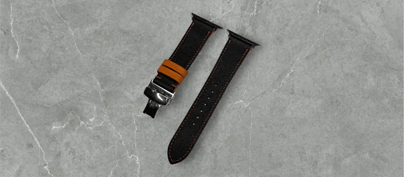 Stylish black and orange swift leather Apple Watch band on a wrist