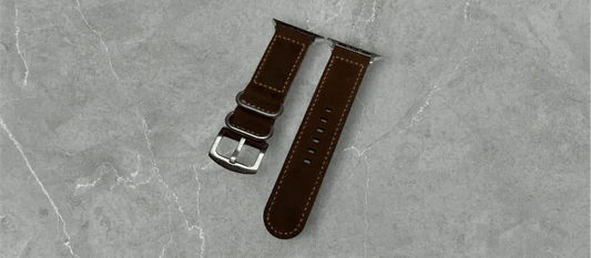 Classic dark brown waxy leather Apple Watch band elegantly displayed on a wooden surface