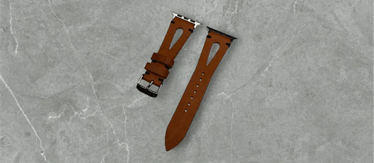 Classic light brown Pueblo leather Apple Watch band laid elegantly on a wooden surface