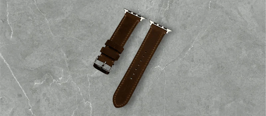 Stylish brown waxy leather Apple Watch band placed elegantly on a marble surface