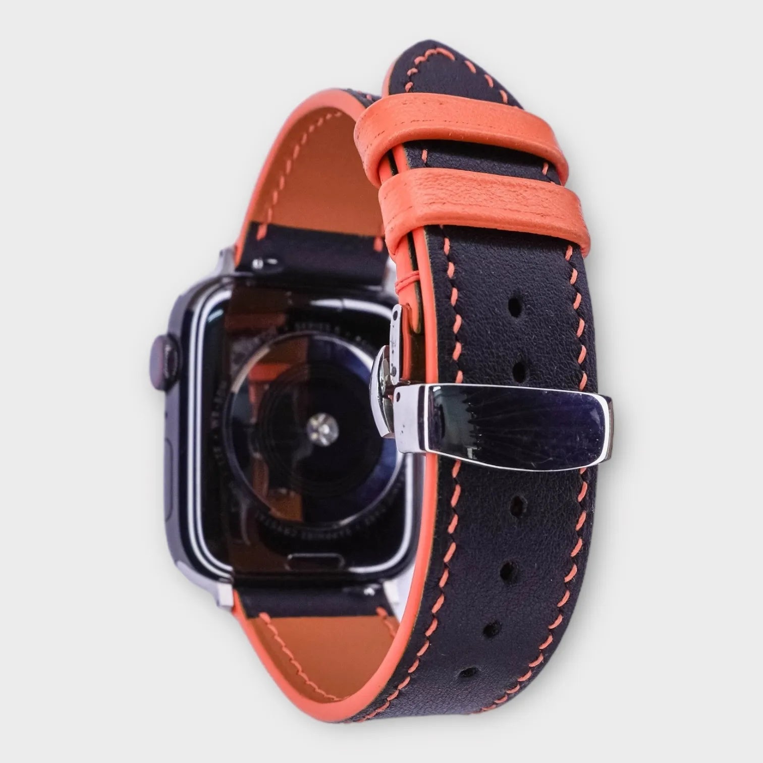 Striking apple watch leather band in black and orange Swift leather, vibrant and bold.