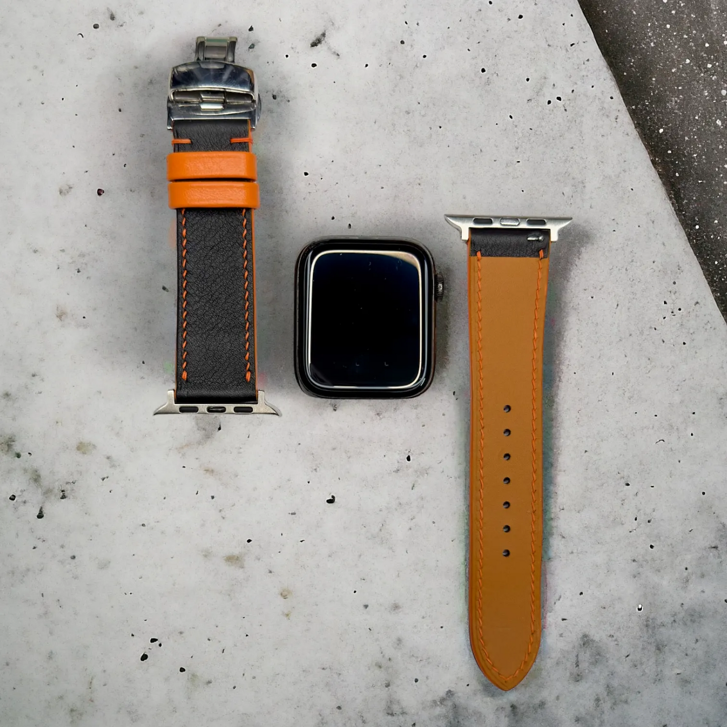 Trendy leather iwatch band in black Swift leather with orange detailing, stylishly designed for everyday wear.