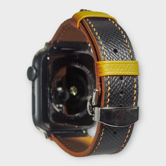 Apple watch bands in black Epsom leather with contrasting orange stitching, adding sophistication to your wearable tech.