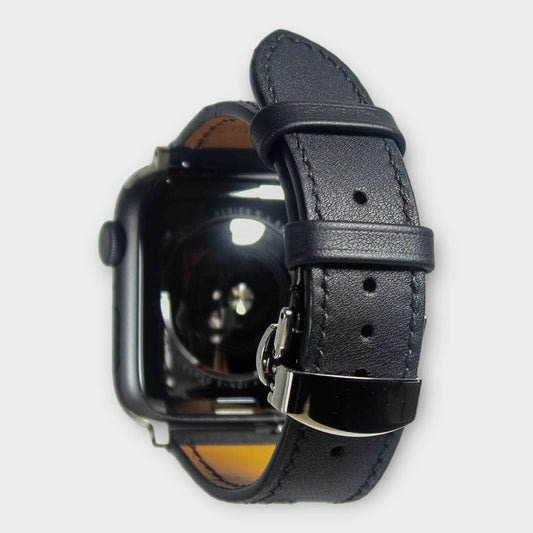 Apple watch bands in sleek black Swift leather with matching black stitching, perfect for a minimalist look.