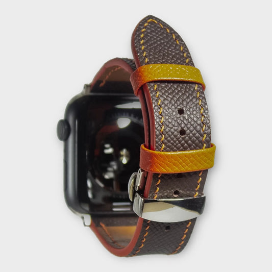 Apple watch bands in brown Epsom leather with vibrant orange stitching, perfect for a stylish and bold look.