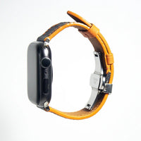 Sleek apple watch leather band in black Epsom leather enhanced with bright orange stitching for a modern twist.