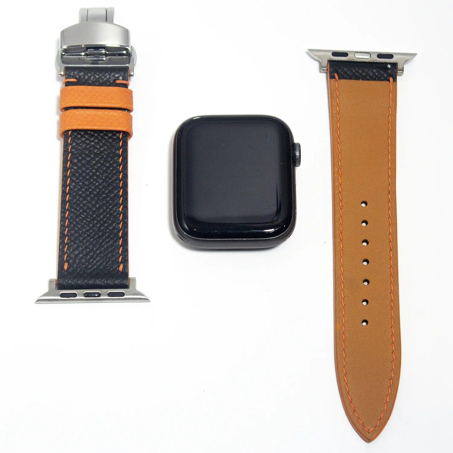 Fashion-forward apple watch straps in black Epsom leather, accented with orange stitching, ideal for adding a splash of color to any outfit.