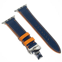 Trendy leather Apple Watch band featuring blue Epsom leather with orange stitching, blending style and contrast.