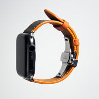 Stylish apple watch leather band crafted from gray Swift leather, accented with vibrant orange stitching.